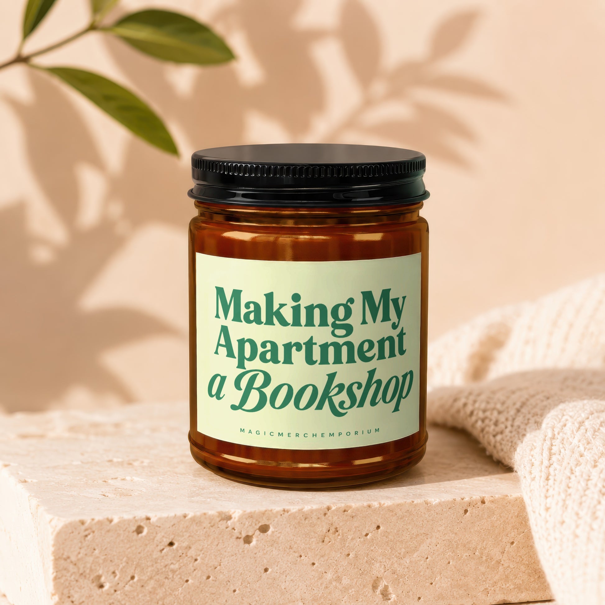 Candle with text "Making My Apartment a Bookshop" and "MagicMerch Emporium"