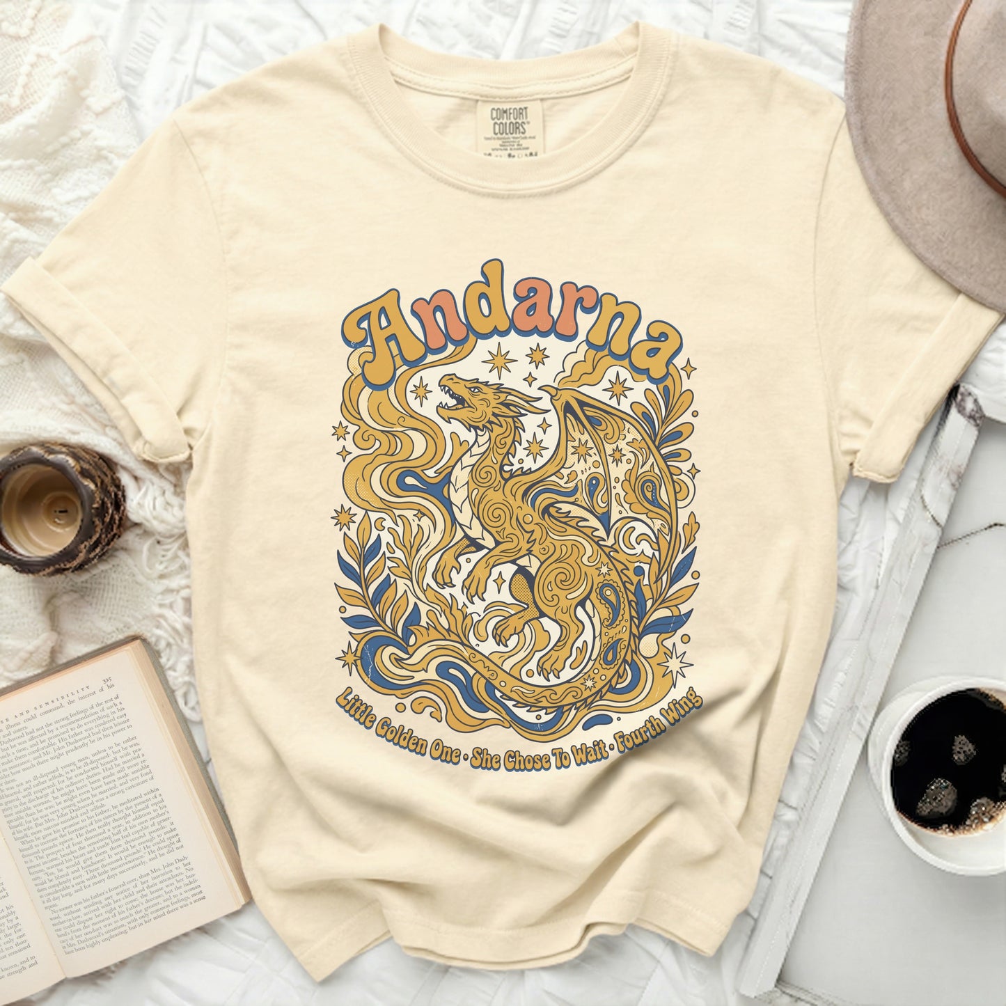 Cream t-shirt with gold dragon graphic and "Andarna Little Golden One • She Chose To Wait Fourth Wing" text.