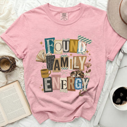 Pink t-shirt with "FOUND FAMILY ENERGY" text collage and cat graphic.