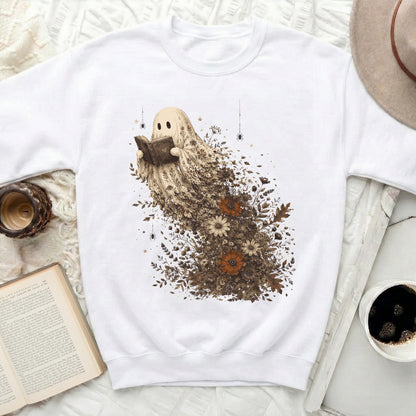 White crewneck sweatshirt featuring a ghost character reading a book surrounded by flowers.