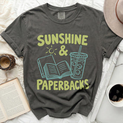 Dark gray t-shirt with "Sunshine & Paperbacks" graphic featuring an open book and iced drink.