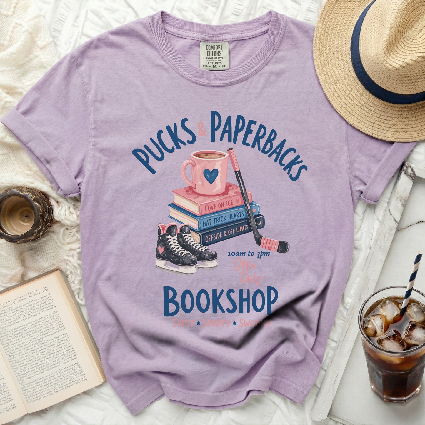 T-shirt with "Pucks & Paperbacks Bookshop" text and hockey skates.