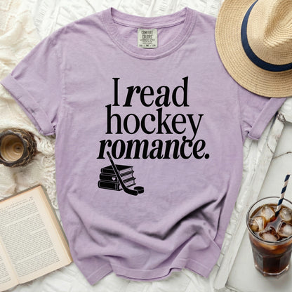 Lavender t-shirt with "I read hockey romance" and hockey pucks design.