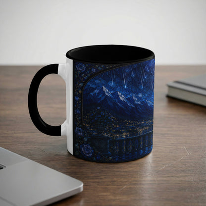 White mug with black handle featuring a stained-glass design of a starry night over mountains and a city.