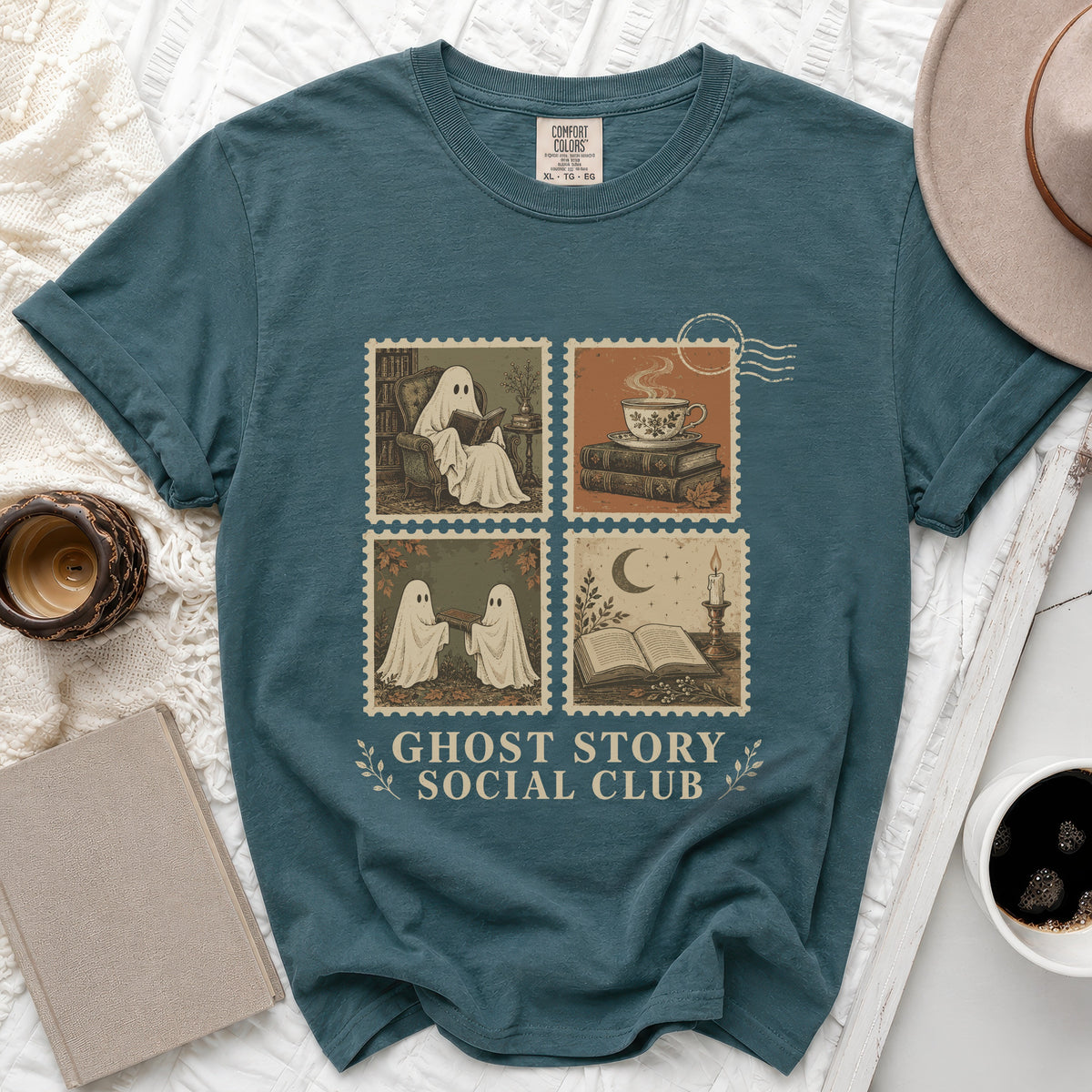 Teal t-shirt with "Ghost Story Social Club" text and four postage stamp-style illustrations of ghosts.
