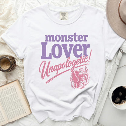 White t-shirt with "monster Lover Unapologetic!" in purple and pink text.