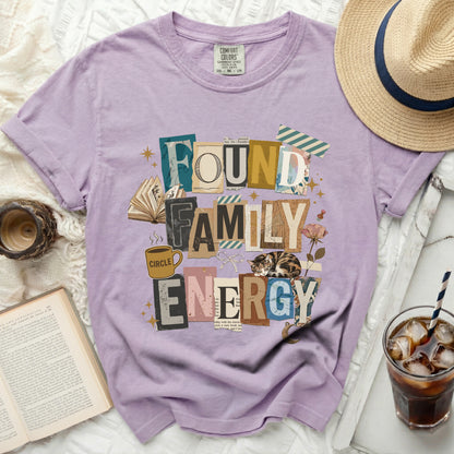 Found Family Energy graphic tee with books, cat, coffee cup and flowers.