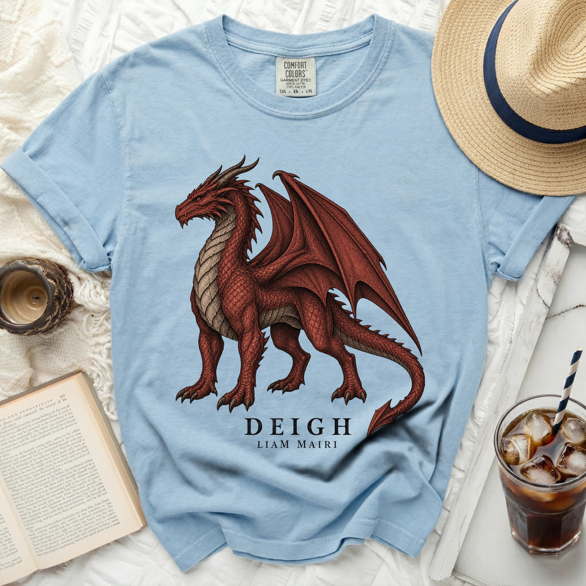 Light blue t-shirt with a red dragon graphic and "DEIGH LIAM MAIRI" text.