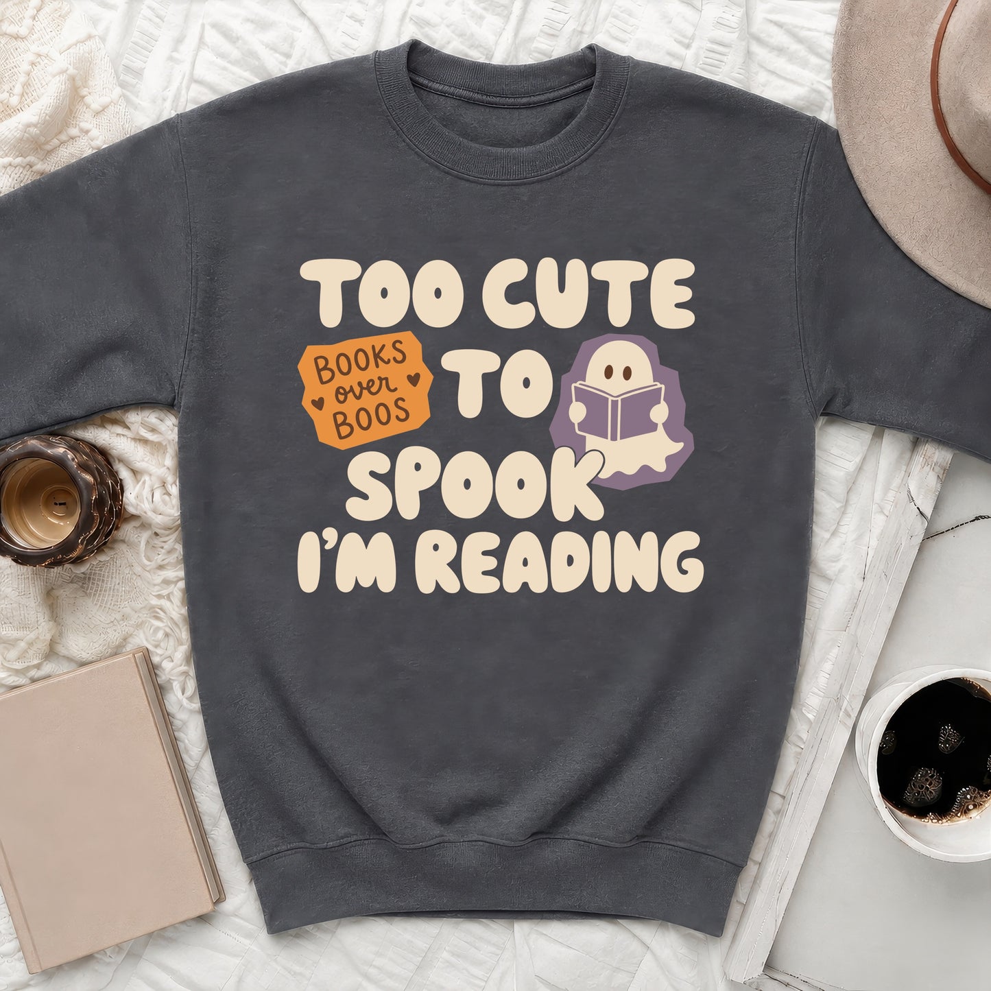Dark gray sweatshirt with "Too Cute To Spook I'm Reading" text and ghost graphic.