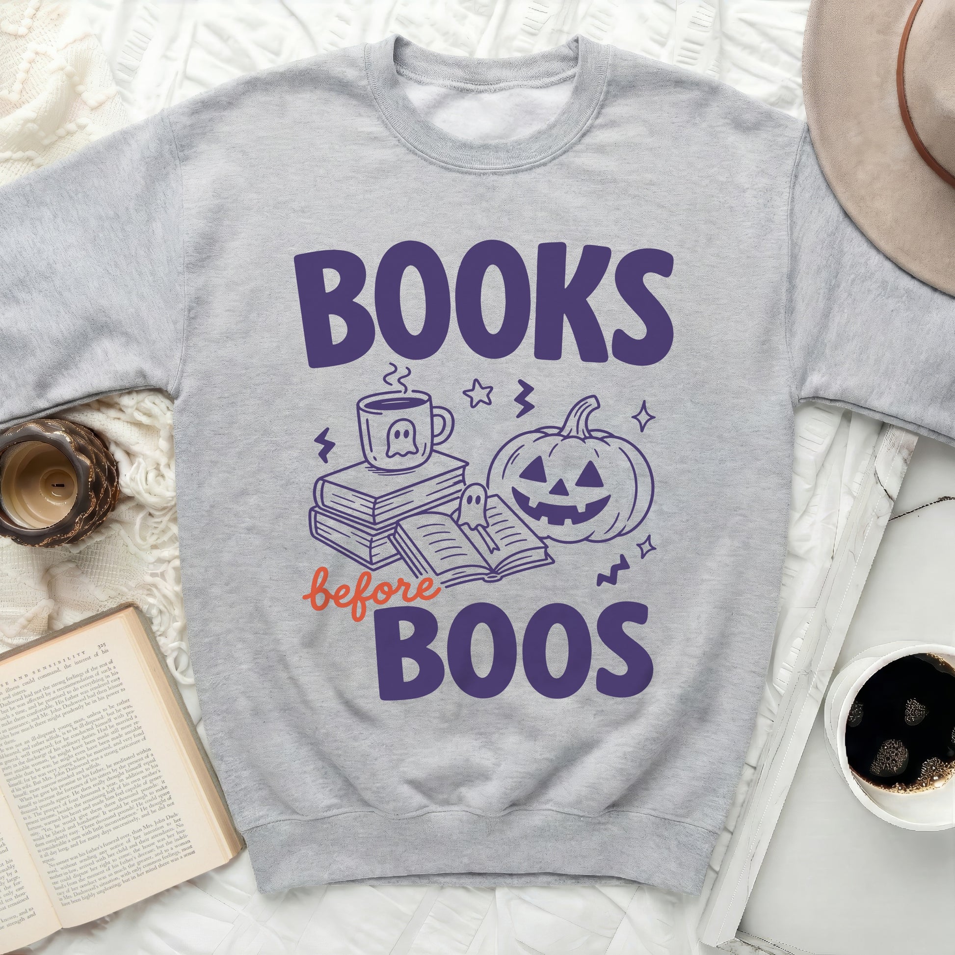 Gray crewneck sweatshirt with "Books before Boos" Halloween graphic.