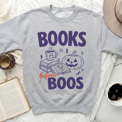 Gray crewneck sweatshirt with "Books before Boos" Halloween graphic.
