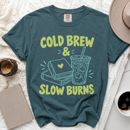 T-shirt with "Cold Brew & Slow Burns" text, books, and iced coffee graphic.