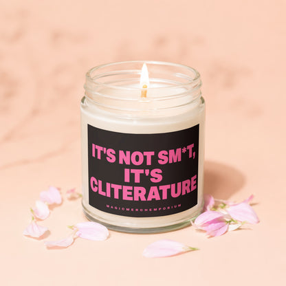 Candle with black label reading "It's not sm*t, It's Cliterature" and "Magic Merch Emporium."