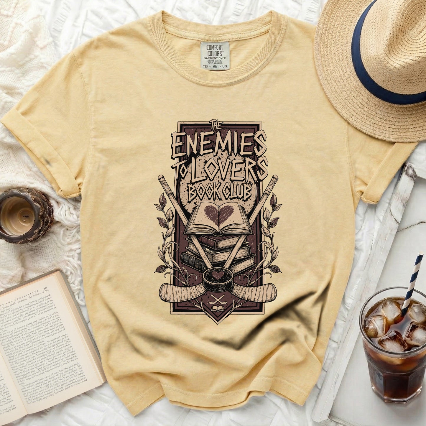 Yellow t-shirt with "The Enemies To Lovers Book Club" graphic.