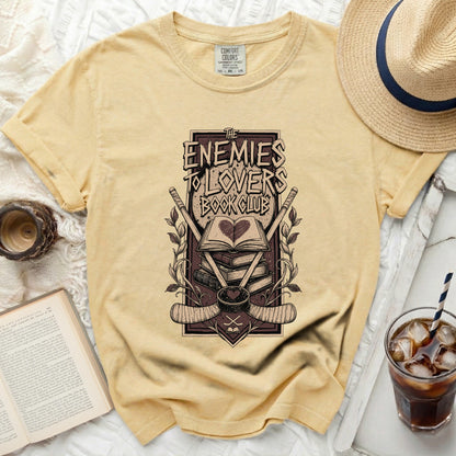 Yellow t-shirt with "The Enemies To Lovers Book Club" graphic.