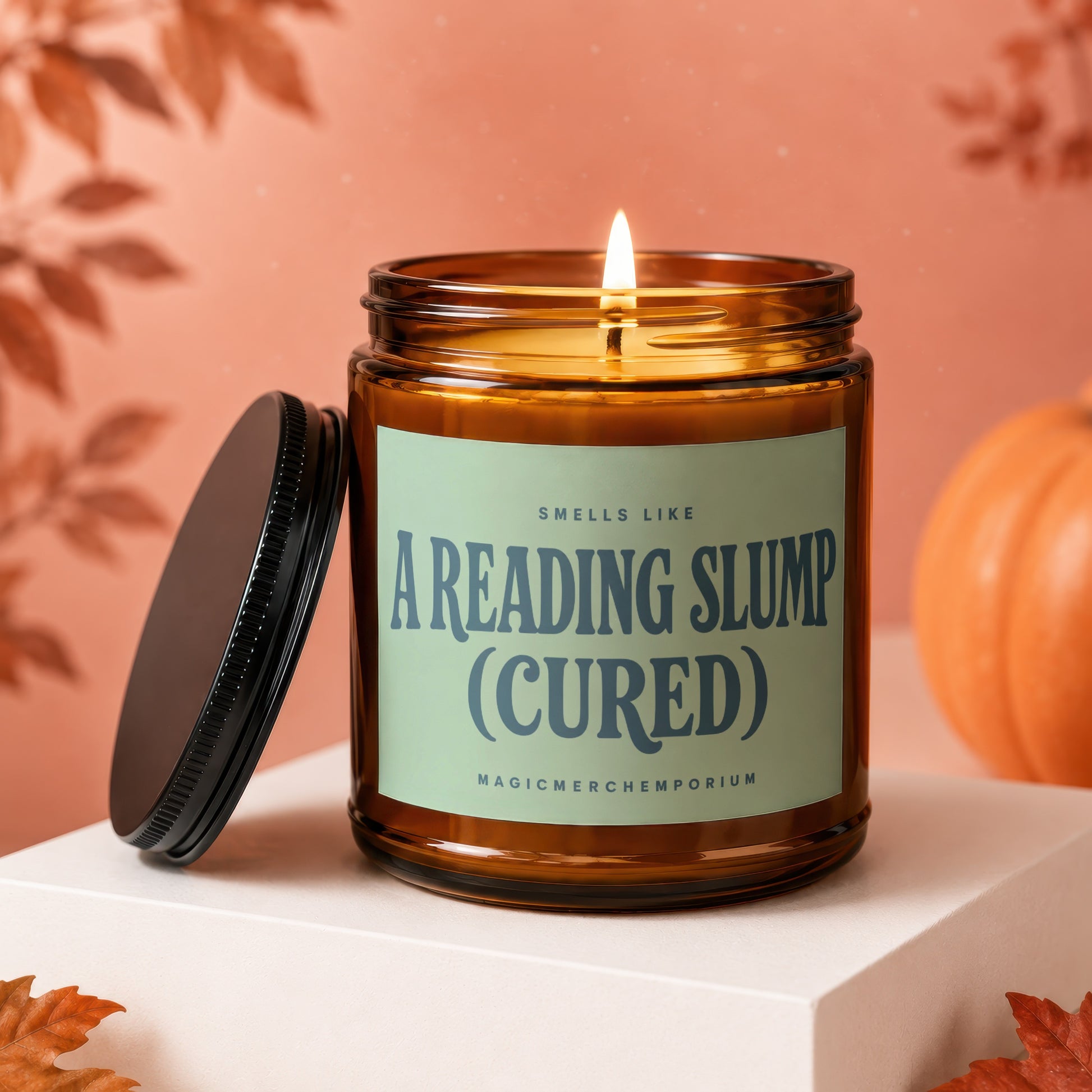Amber glass candle with "Smells Like A Reading Slump (Cured)" label.