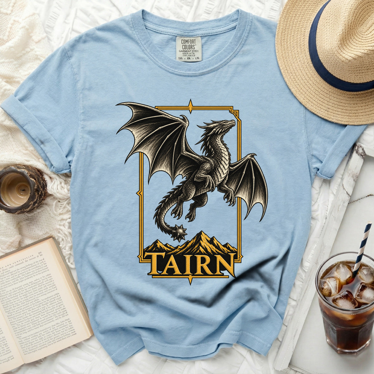 Light blue t-shirt with a black dragon graphic and "TAIRN" text.