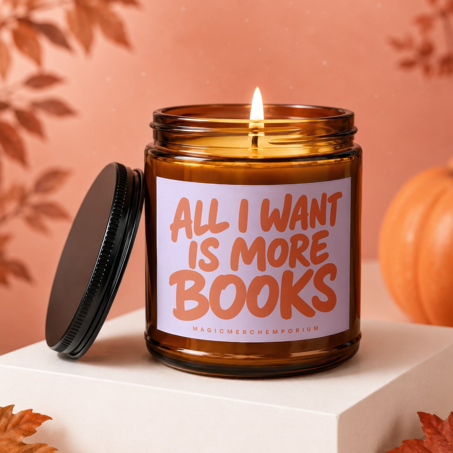 Amber glass candle with lit wick, "All I Want Is More Books" text.