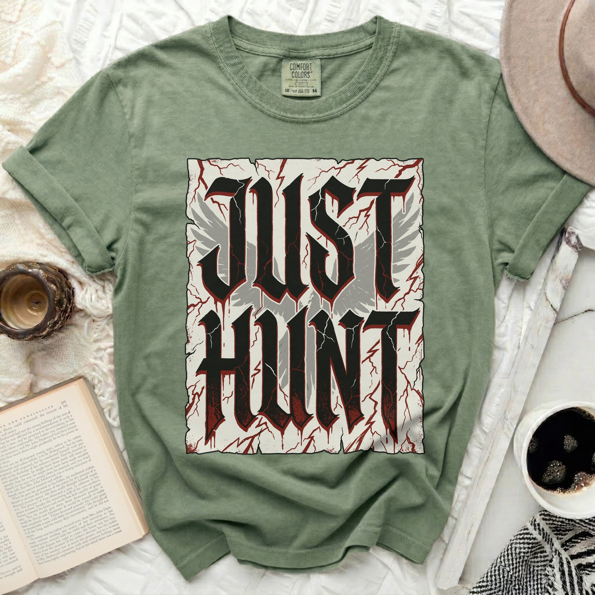 Green t-shirt with "JUST HUNT" text in stylized gothic font with wings.