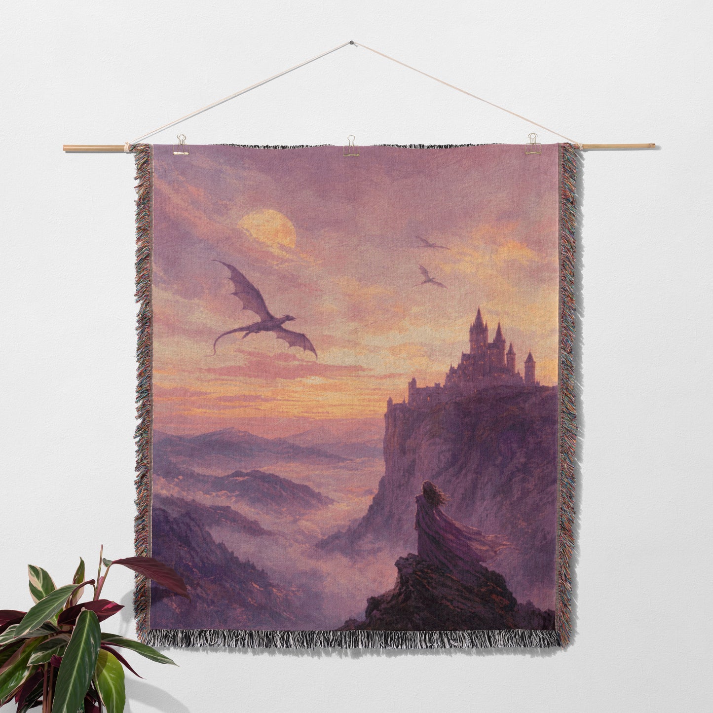a large dragon flying over a castle in a mountainous landscape at sunset.