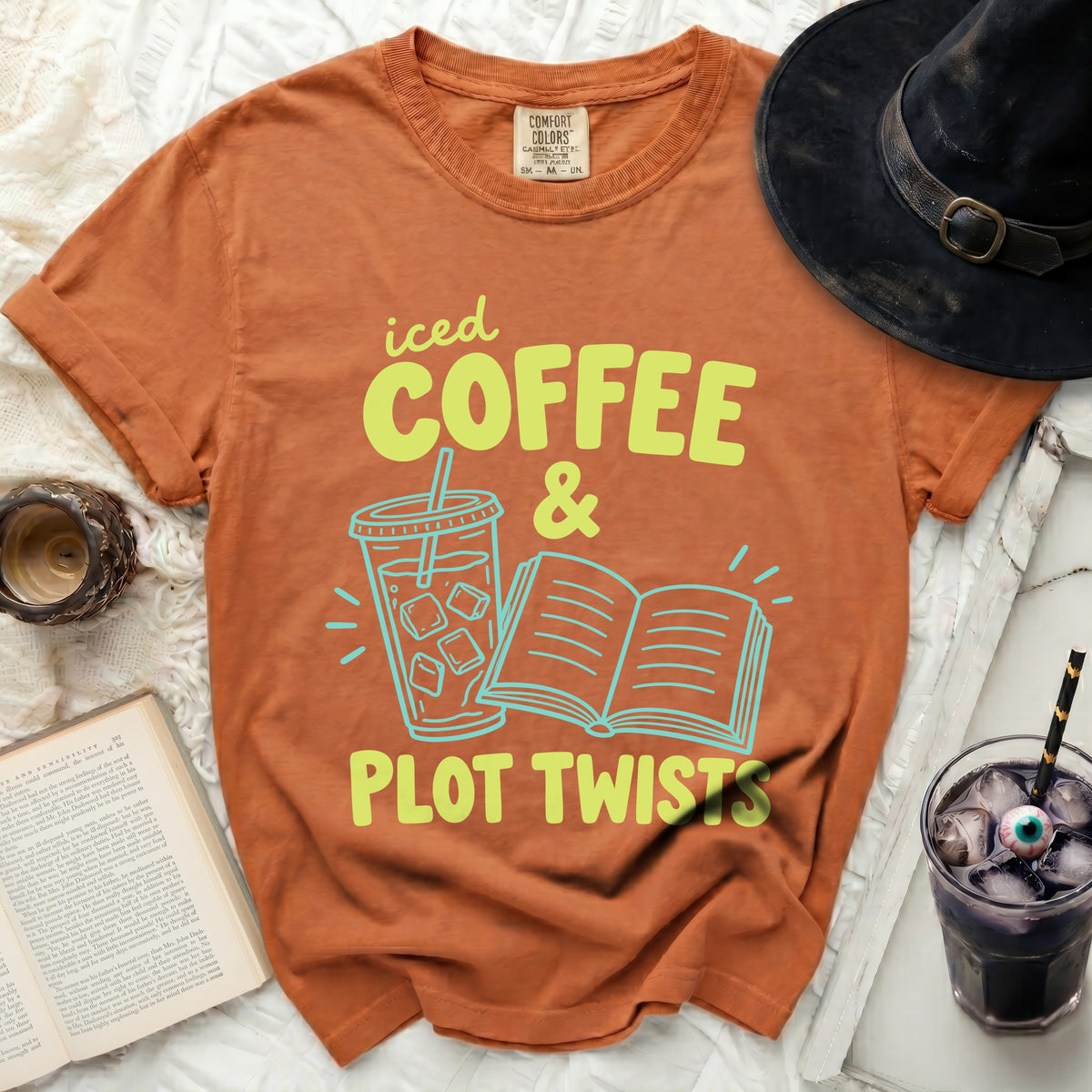Orange t-shirt with text "iced COFFEE & PLOT TWISTS".