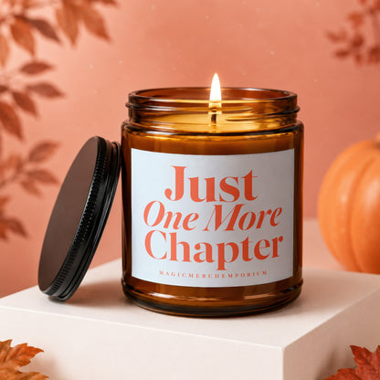 Amber jar candle with "Just One More Chapter" text and a lit flame.