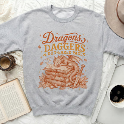 Grey sweatshirt with "Dragons, Daggers & Dog-Eared Pages" graphic.