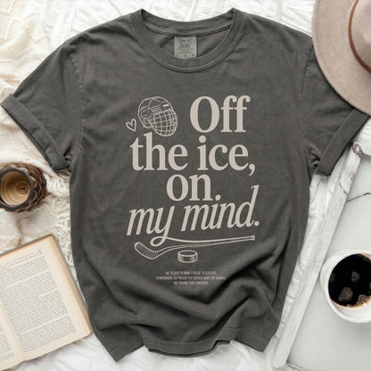 Dark grey t-shirt with "Off the ice, on my mind." text and hockey graphic.