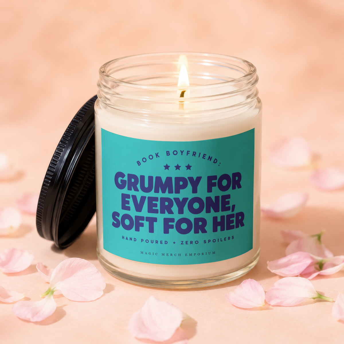 Glass candle with teal label reading "Book Boyfriend: Grumpy For Everyone, Soft For Her".