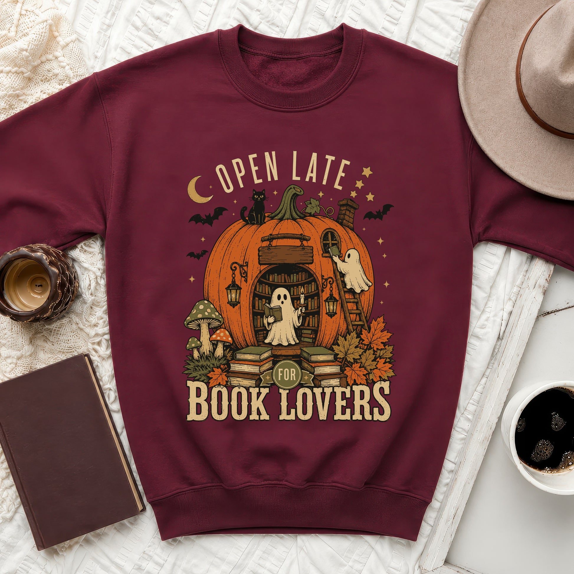 Maroon sweatshirt with Halloween-themed "Open Late for Book Lovers" ghost and pumpkin library graphic.