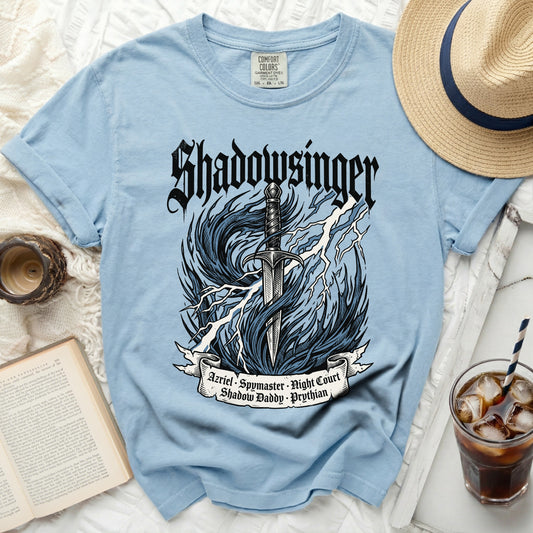 Light blue t-shirt with "Shadowsinger" and sword graphic.
