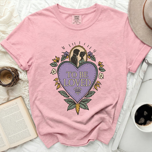 Pink t-shirt with "TO BE LOVED" heart graphic and couple silhouette.