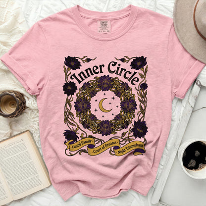 Pink t-shirt with "Inner Circle" graphic featuring a wreath, crescent moon, and banner text.