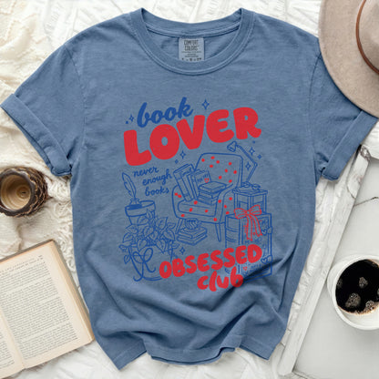 Blue shirt with red and blue graphic "book LOVER never enough books OBSESSED club".