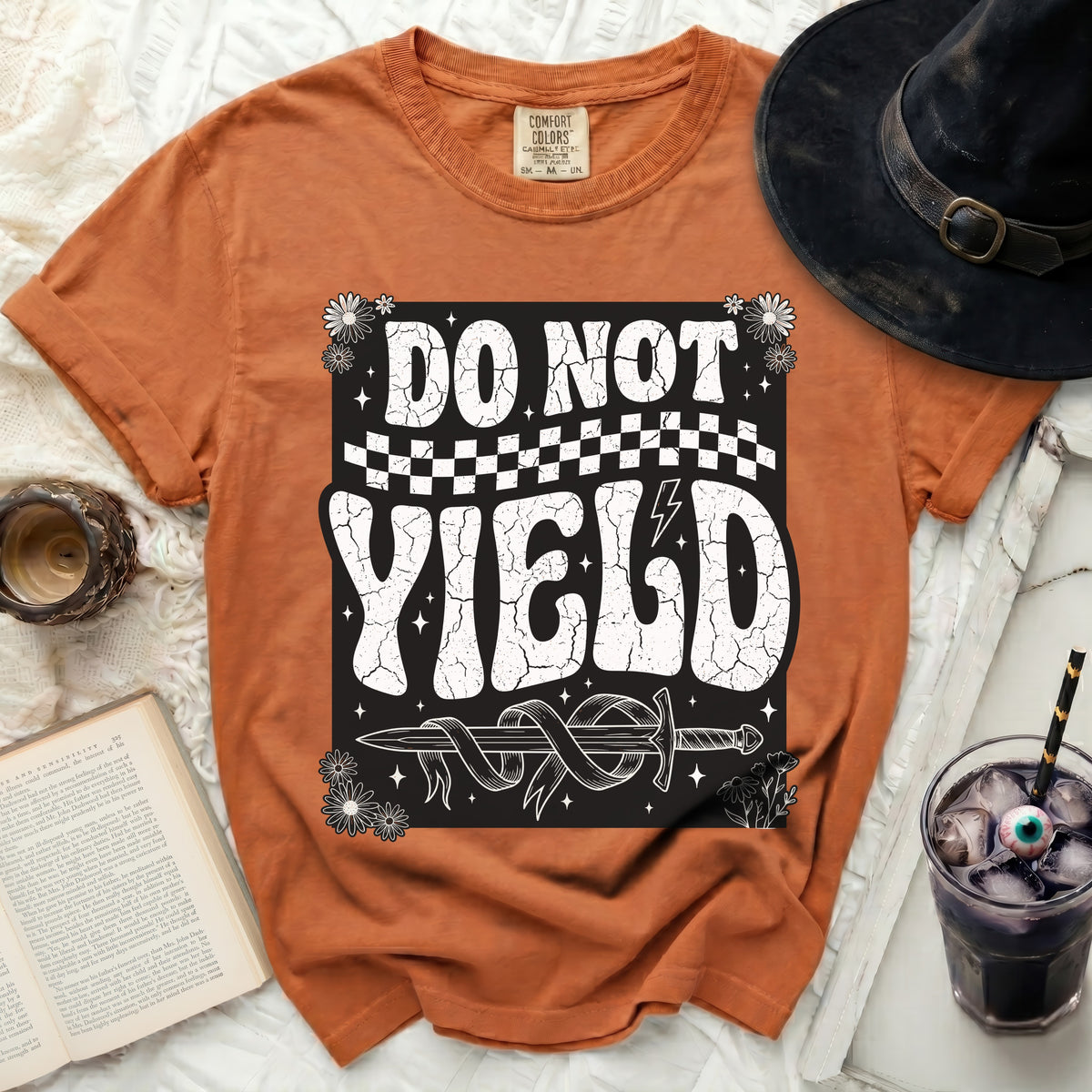 Orange t-shirt with "DO NOT YIELD" and a sword graphic.