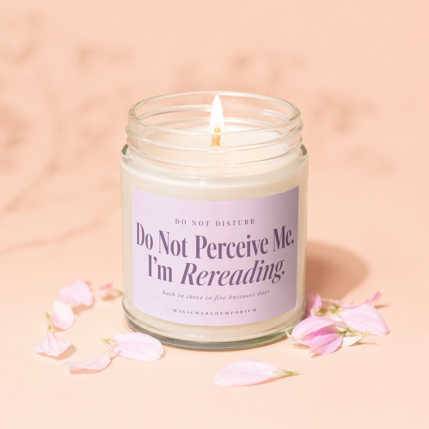 Candle with "Do Not Perceive Me, I'm Rereading" text and petals.
