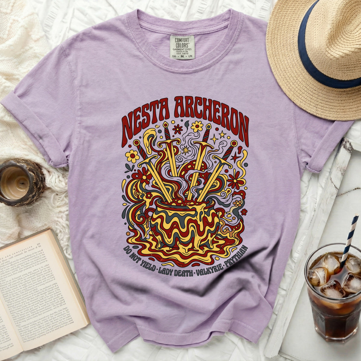 Purple t-shirt with "Nesta Archheron" and cauldron graphic.