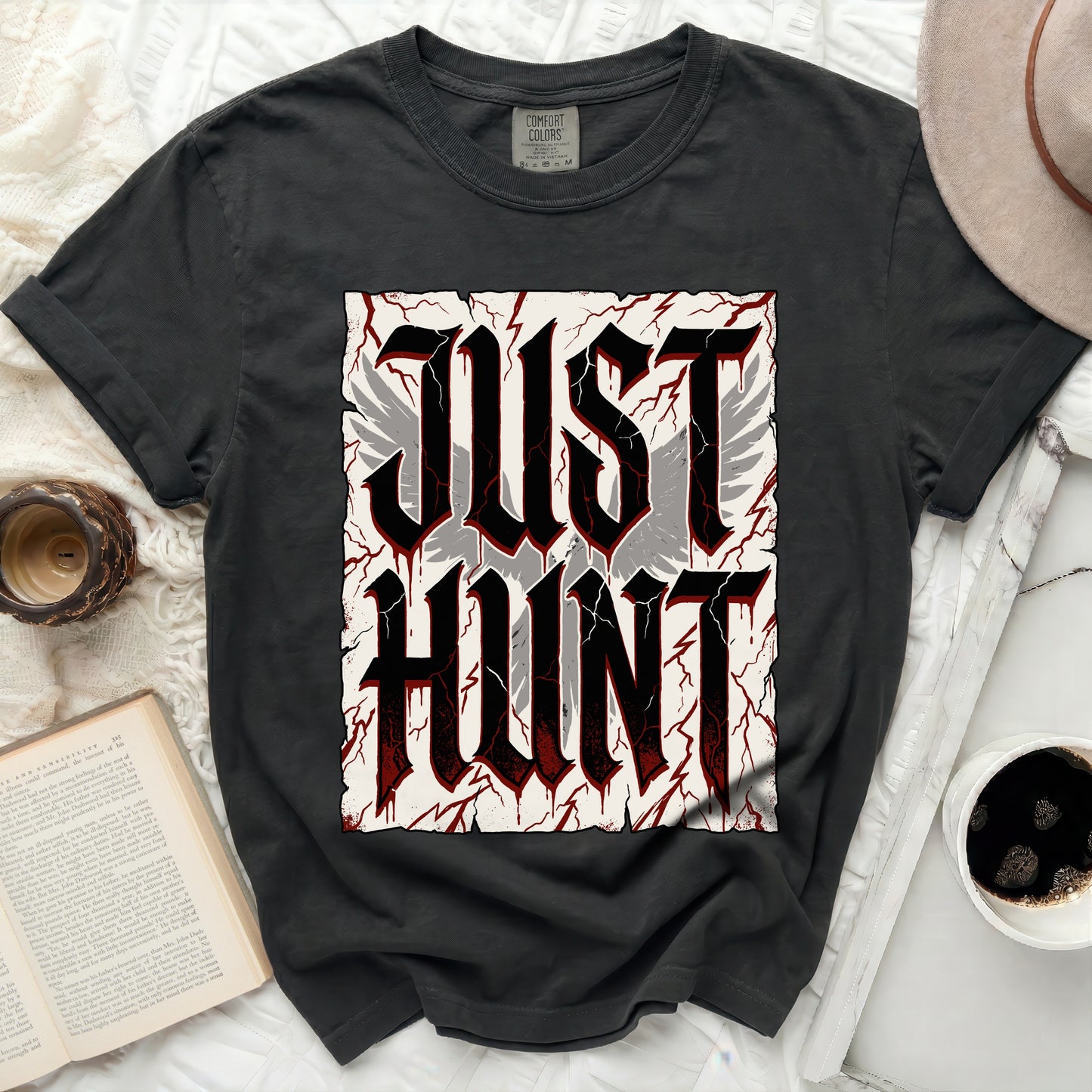 Black t-shirt with "JUST HUNT" in large gothic font and wings.
