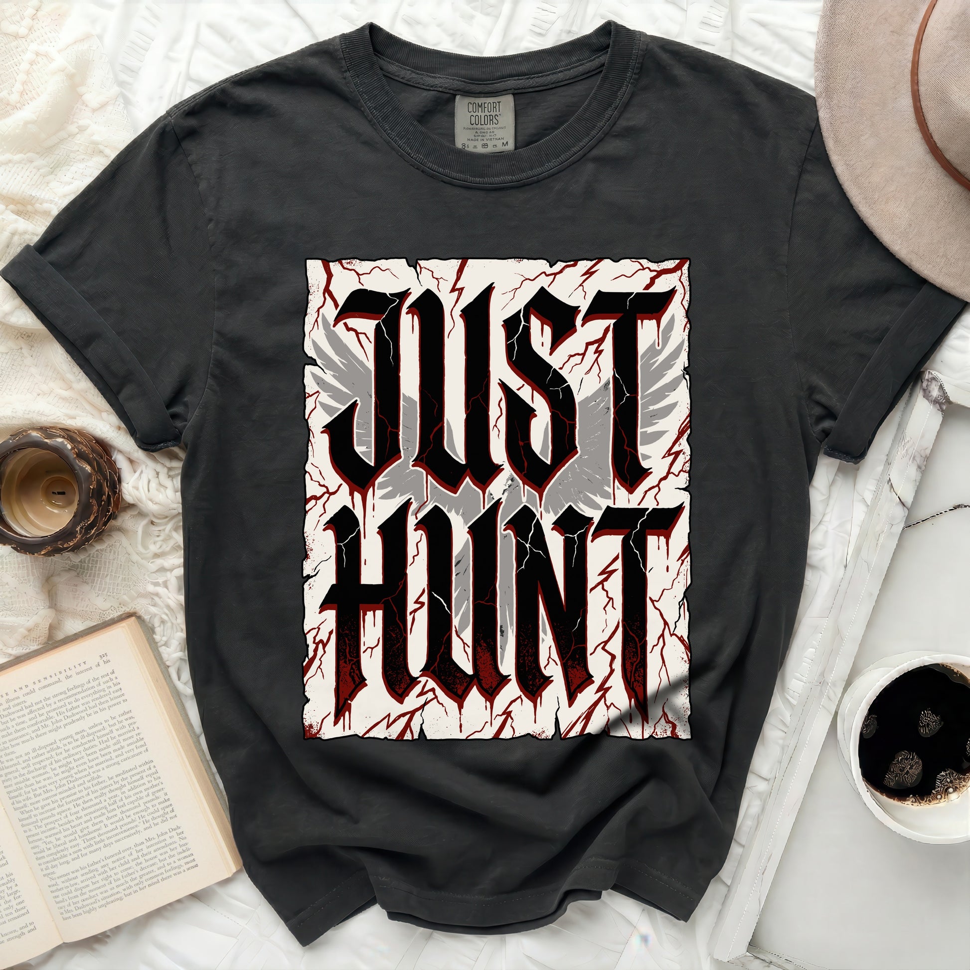 Black t-shirt with "JUST HUNT" in large gothic font and wings.