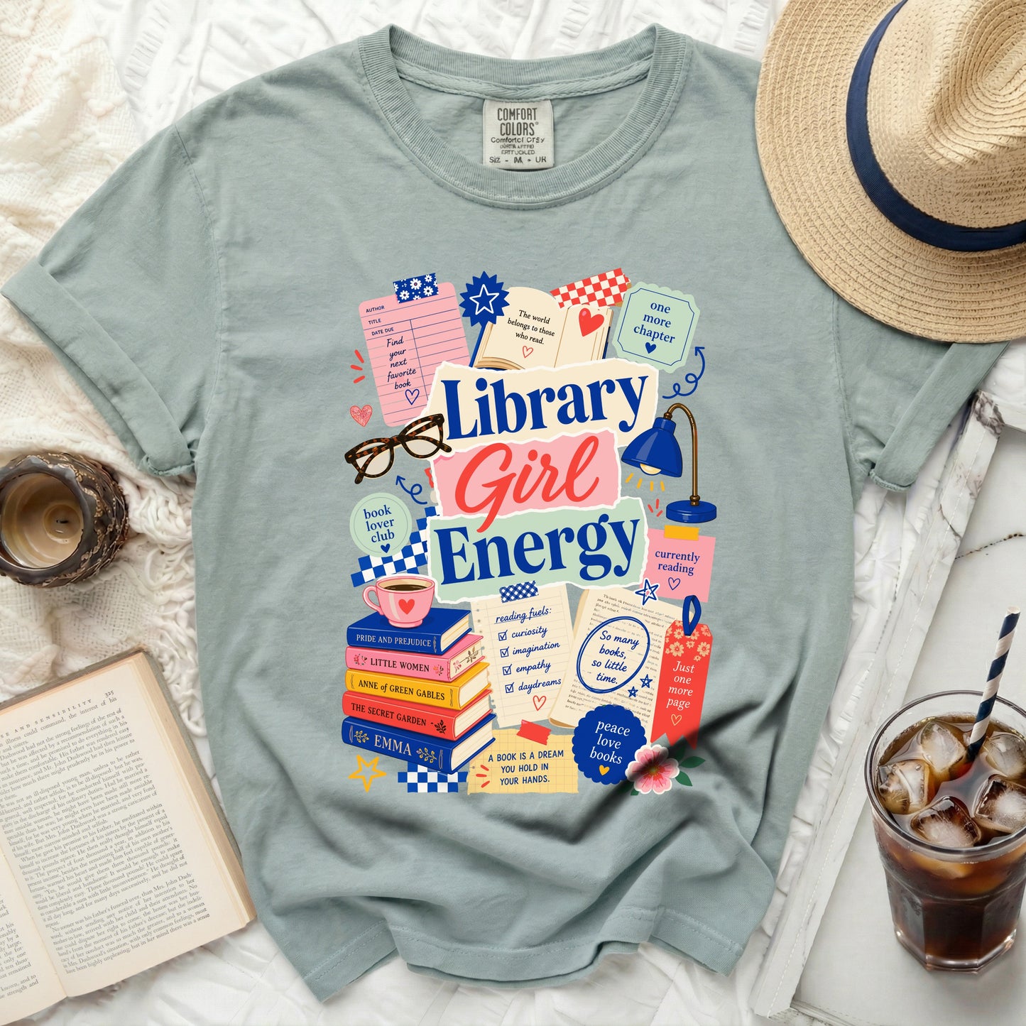 Comfort Colors t-shirt with "Library Girl Energy" graphic and book-themed illustrations.