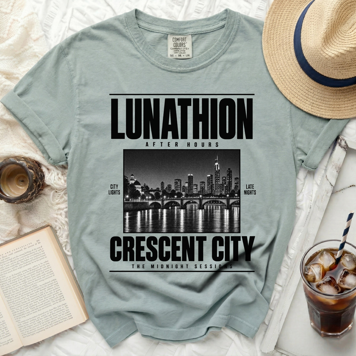Light blue t-shirt with "LUNATHION AFTER HOURS CRESCENT CITY THE MIDNIGHT SESSIONS" text.