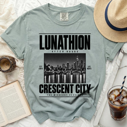 Light blue t-shirt with "LUNATHION AFTER HOURS CRESCENT CITY THE MIDNIGHT SESSIONS" text.