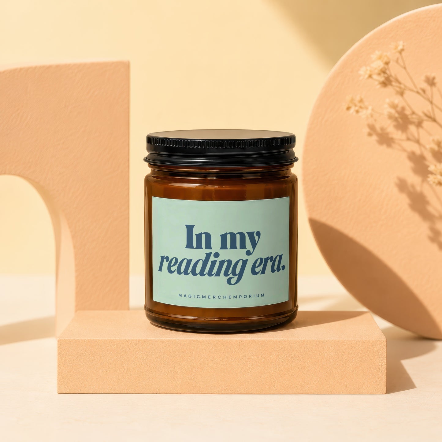 Amber jar candle with black lid and light blue label reading "In my reading era."