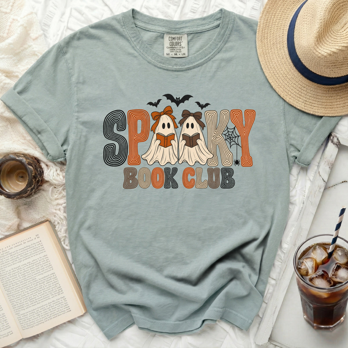 Light blue t-shirt with "Spooky Book Club" text and ghost illustrations.