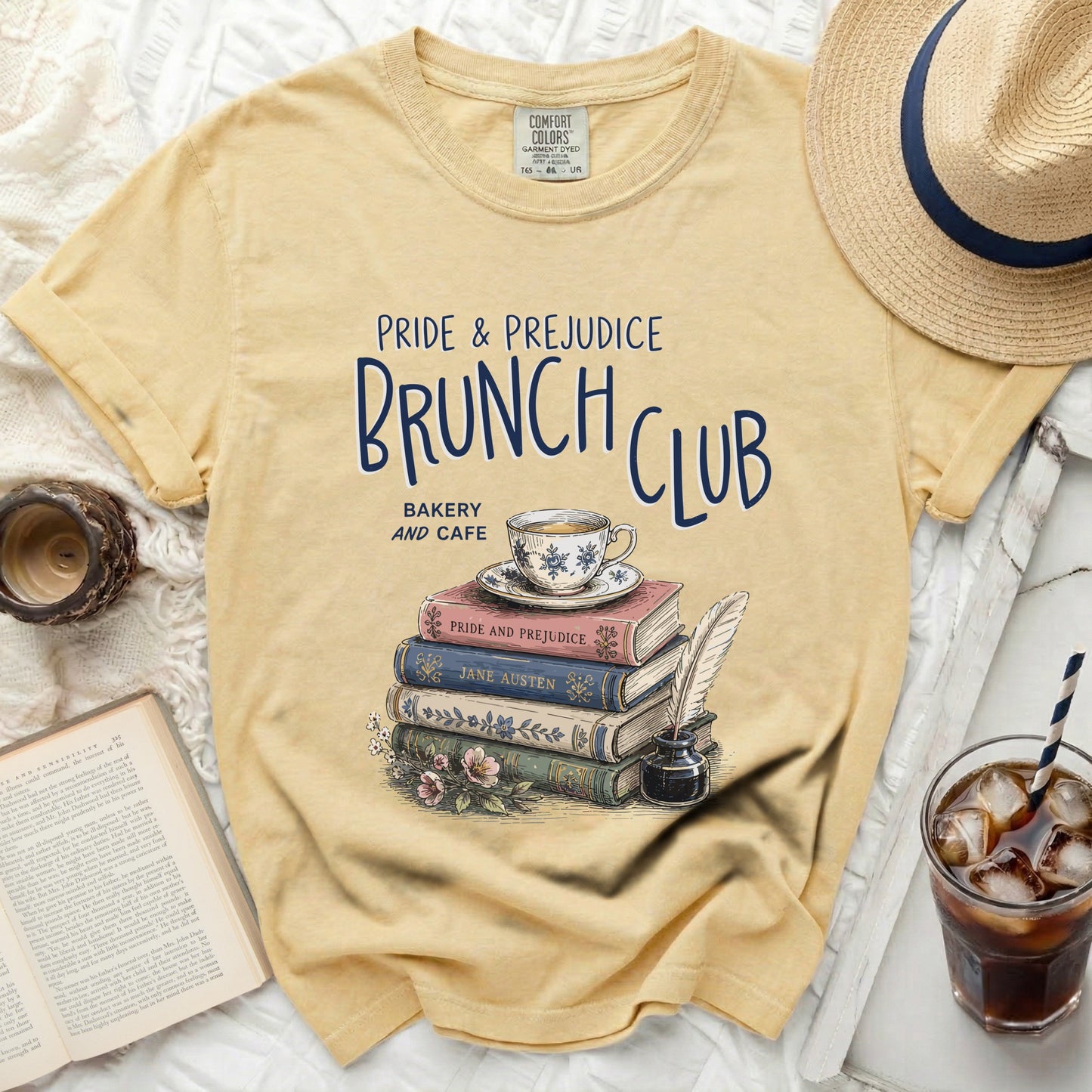 Yellow t-shirt with "Pride & Prejudice Brunch Club Bakery and Cafe" graphic.