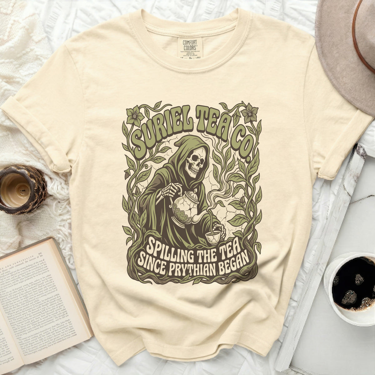 Grim reaper pouring tea surrounded by vines, "Suriel Tea Co. Spilling The Tea Since Prythian Began."