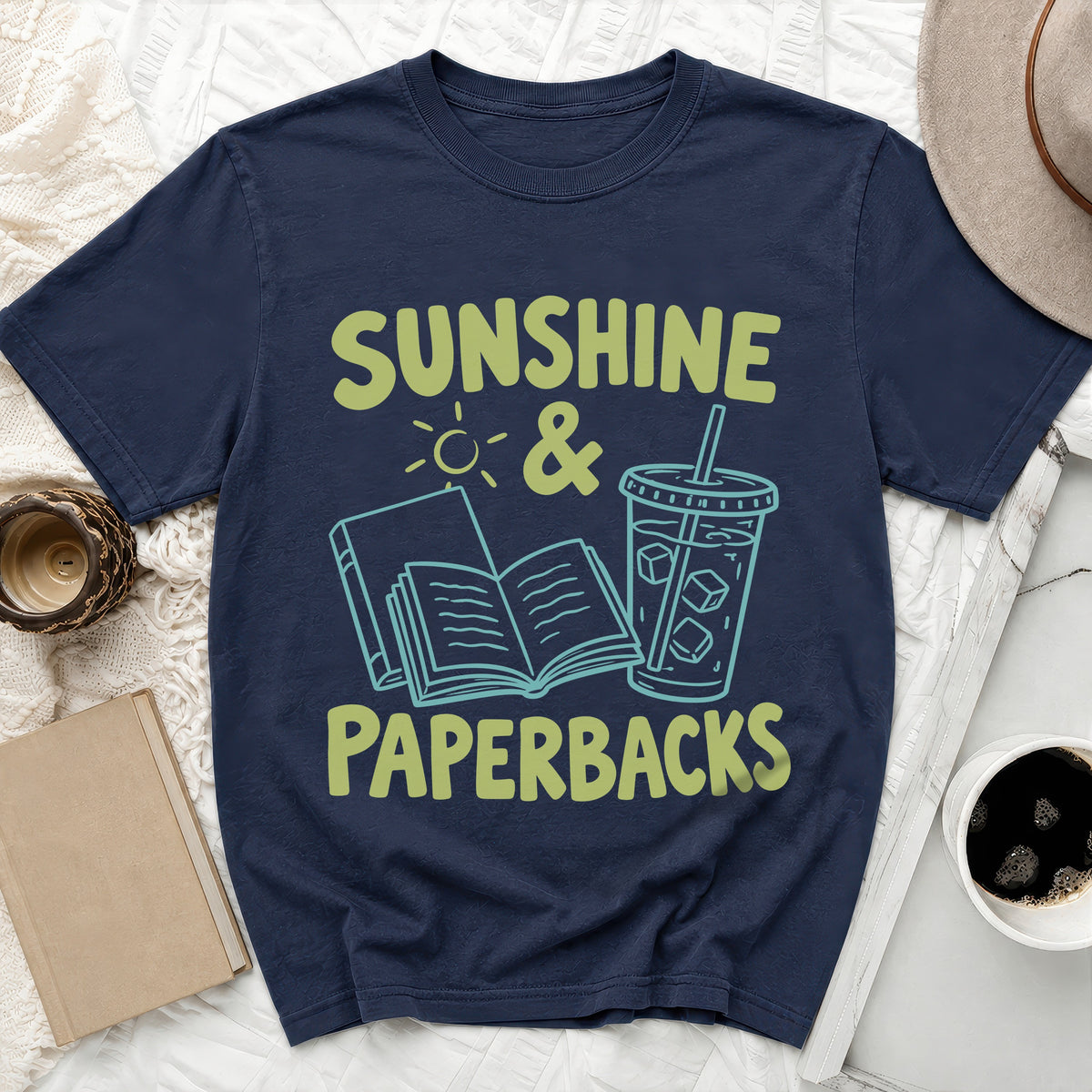 Navy t-shirt with "Sunshine & Paperbacks" text, an open book, and a drink.