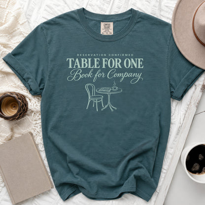 Teal t-shirt with "Table for One Book for Company" text and illustration.