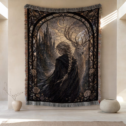 a large tapestry hanging on a wall, depicting a woman with long braided hair standing next to a deer. The tapestry is framed by an ornate border and has a dark, moody color scheme. There are two small vases placed on either side of the tapestry, and the overall composition creates a sense of balance and harmony.