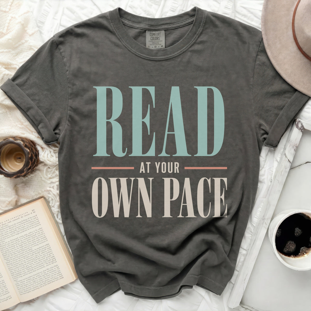 Charcoal grey t-shirt with "READ AT YOUR OWN PACE" text.